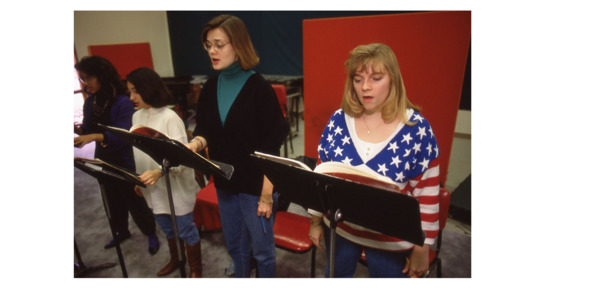 Female students sing in choir class